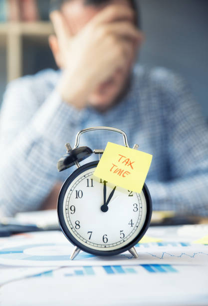 istock Man working on desk with an alarm clock 1151563966