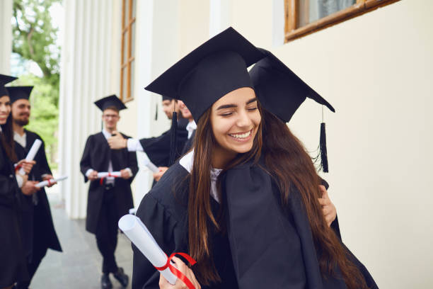 istock Female graduates with diplomas in their hands hugging 1151567141
