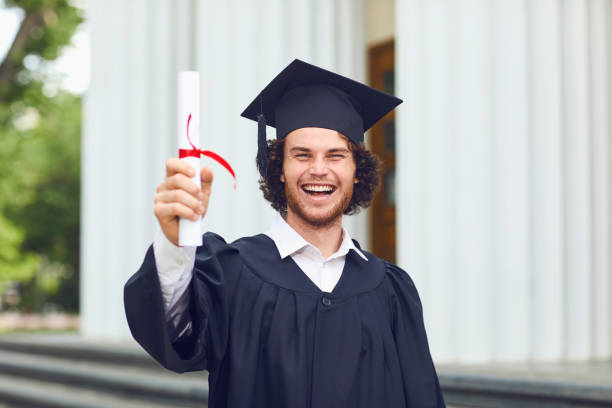 istock A young man graduate is smiling on university graduates. 1151567143