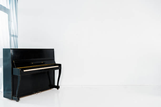 istock black piano on white background with copy space 1151567877
