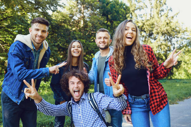 istock Friends walk laughing in the park. 1151568298