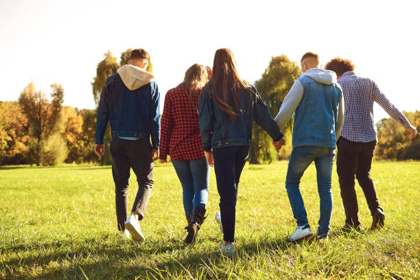 istock Young people walk in the park in spring. 1151568304