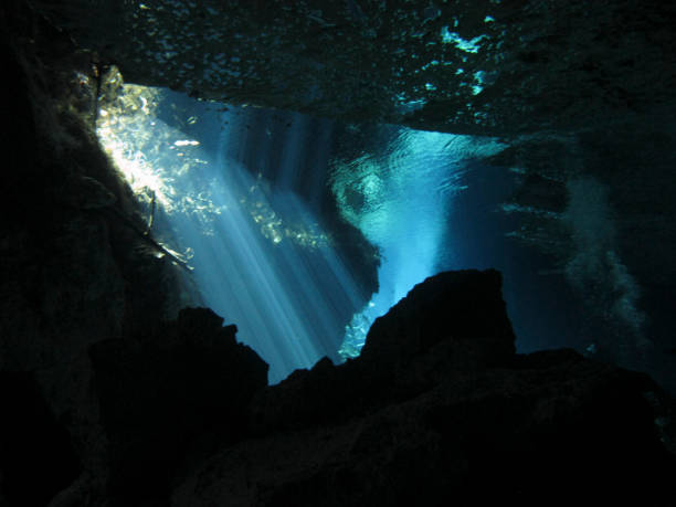 istock Sun rays entering the water in an underwater cave. 1151573768