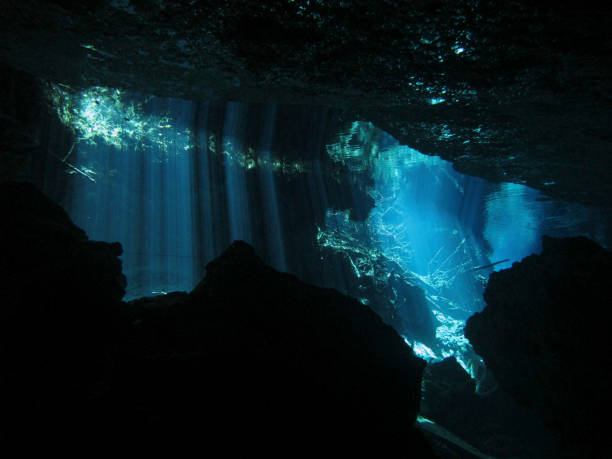 istock Sun rays entering the water in an underwater cave. 1151574282