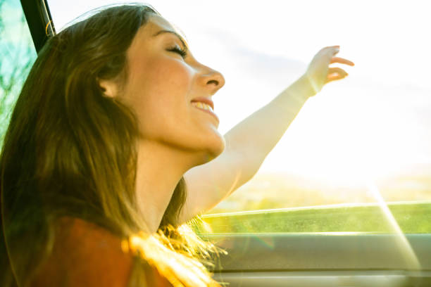 istock Girl at car window enjoying wind 1151579115