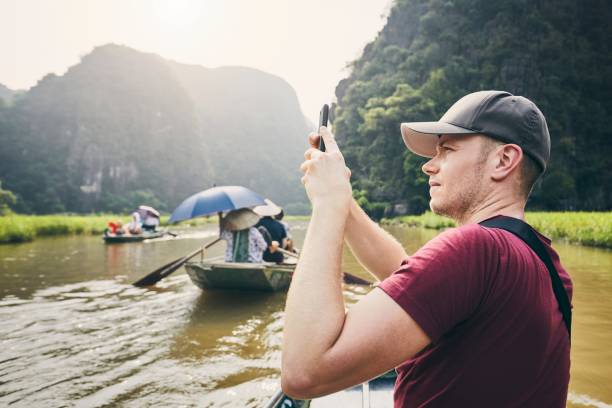 istock Tourist with mobile phone on boat 1151579303