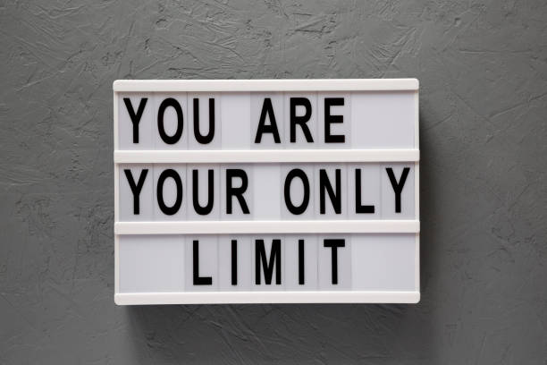 istock 'You are your only limit' words on a modern board over concrete surface, top view. Overhead, from above. Flat lay. 1151584324