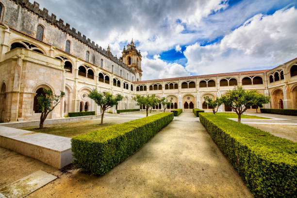 Cloister and Church Tower of the Alcobaca Monastery (Mosteiro de Santa Maria de Alcobaca), Portugal Cloister and church tower of the Alcobaca Monastery (Mosteiro de Santa Maria de Alcobaca), Portugal alcobaca photos stock pictures, royalty-free photos & images