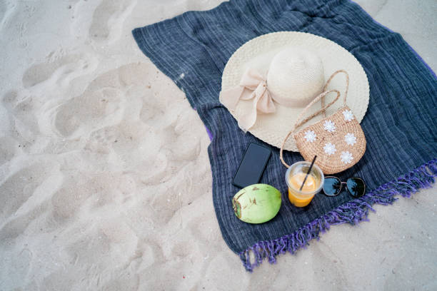 istock Summer beach bag sea hat and sunglasses on sandy beach 1151586142