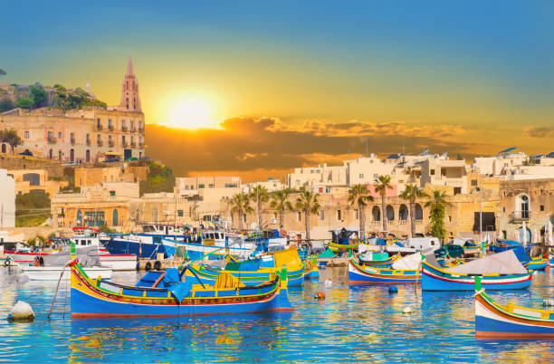 Harbor of Malta in sunset light Marsaxlokk village harbor of Malta, illuminate by sunset light malta stock pictures, royalty-free photos & images