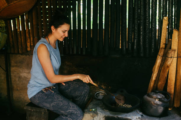 istock Young woman roasting Balinese coffee 1151590277
