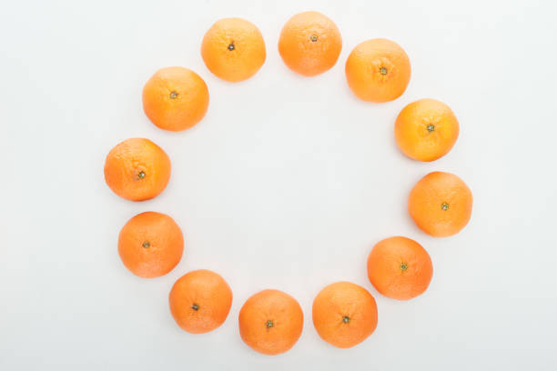 round frame of ripe orange tangerines on white background with copy space