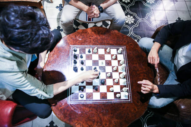 istock Young male friends playing chess 1151592956