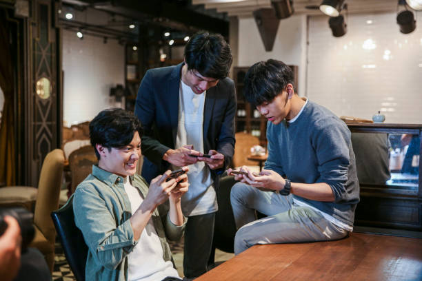 istock Young friends playing mobile game in cafe 1151593504