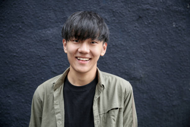 istock Portrait of young man with dark grey background 1151593683