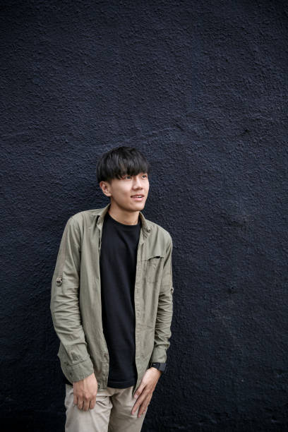 istock Portrait of young man with dark grey background 1151593807