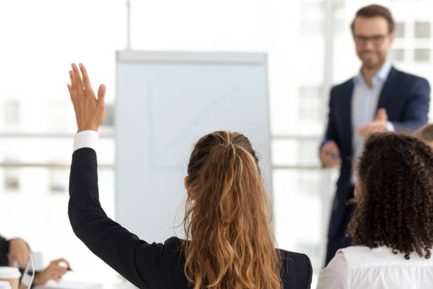 istock Training participant raise hand ask question at employees team workshop 1151593851