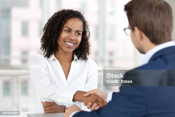 Smiling African Hr Manager Handshake Hire Candidate At Job Interview Stock Photo - Download Image Now
