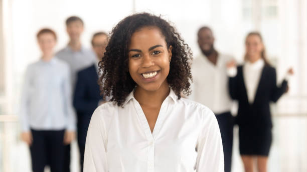 istock Smiling young mixed-race female worker intern standing looking at camera 1151593910