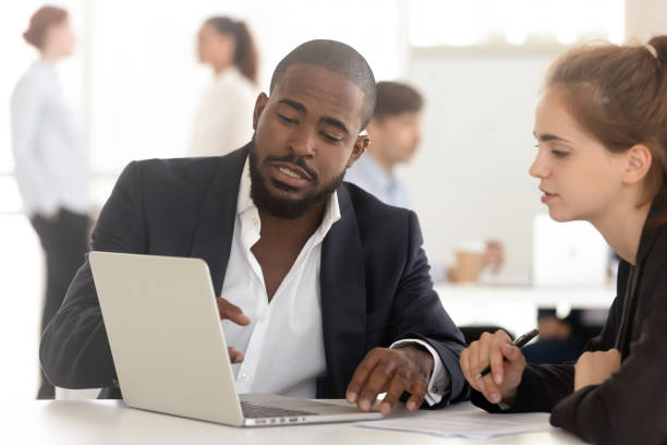 istock Black broker insurer consulting working with client looking at laptop 1151593918