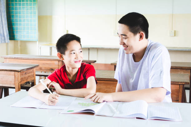 istock Boys learning and doing homework in the classroom together 1151593941