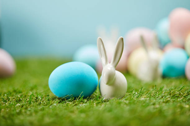 istock selective focus of painted easter eggs and toy rabbits on grass with copy space 1151594009