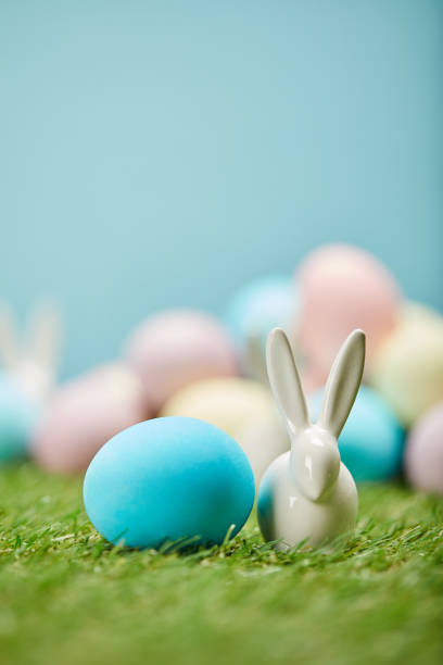 istock selective focus of painted easter eggs and toy rabbit on grass with copy space 1151594014