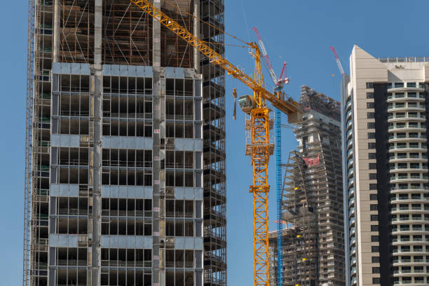 istock A yellow crane stands on a construction site where several skyscrapers are being built. 1151595584