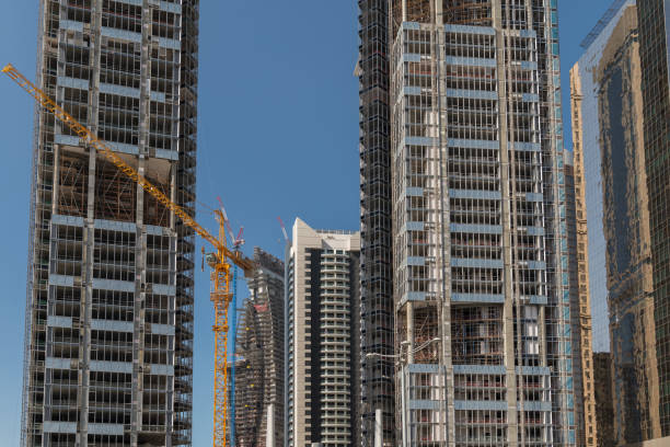 istock Newly constructed skyscrapers on a construction site, a yellow crane is in the middle. 1151595585
