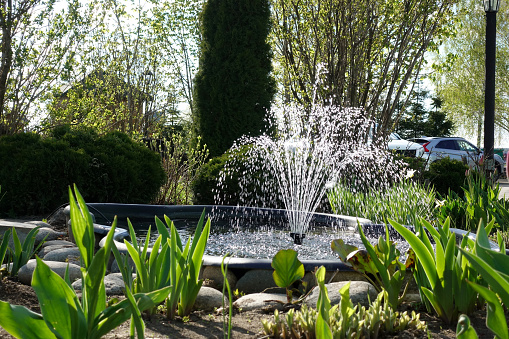 A small fountain in the garden. Garden architecture