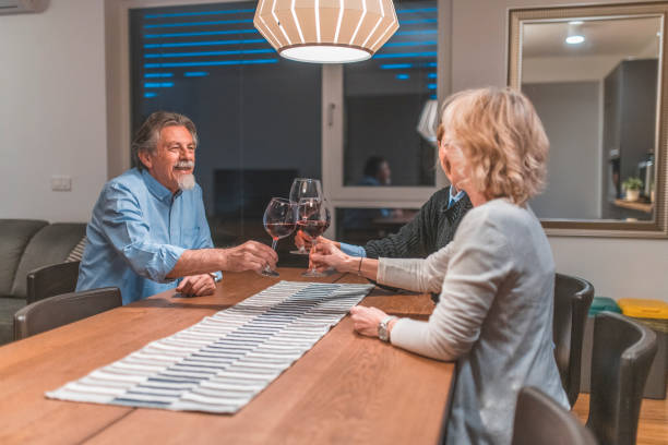istock Smiling family toasting wineglass at dining table 1151597579