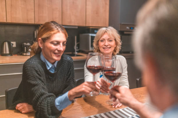 istock Happy family celebrating while toasting wineglass 1151597646