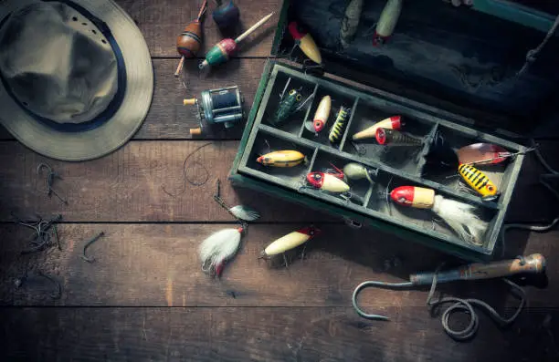 Vintage fishing lures/tackle on an old wood background. Aerial view