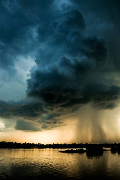 Hurricane over louisiana. Storm clouds and rain over the Mississippi Rain over louisiana. Storm storm clouds in the rays of the evening setting sun lightning storm natural disaster cloud stock pictures, royalty-free photos & images