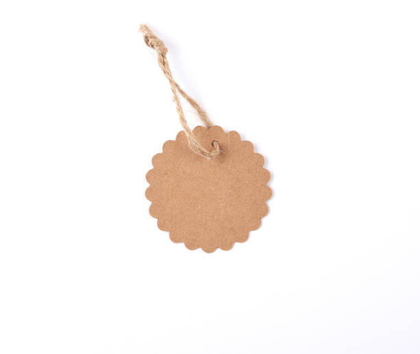 istock empty paper round brown tag on a rope, white background 1151602716