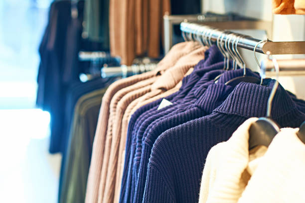 istock Woman pullover sweaters in different colors on hangers in a retail clothes store. 1151606796