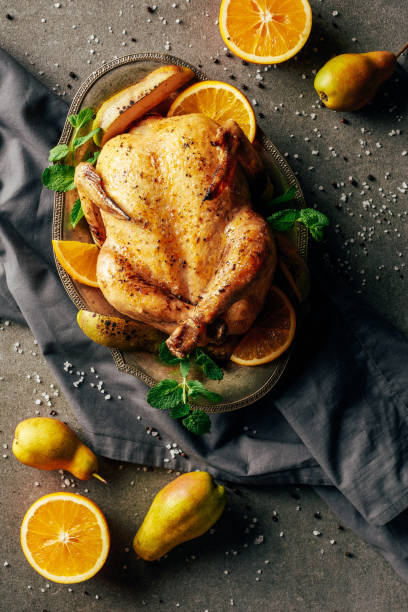 istock top view of fried chicken with oranges, pears and greenery on tray and cloth 1151607954
