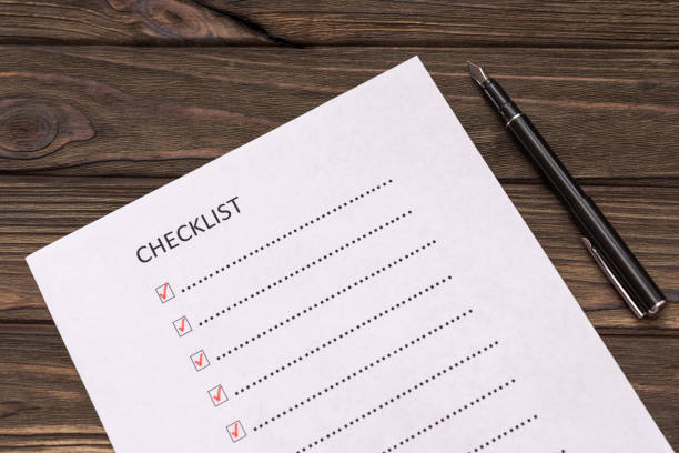 istock Checklist, pen on wooden background 1151608564