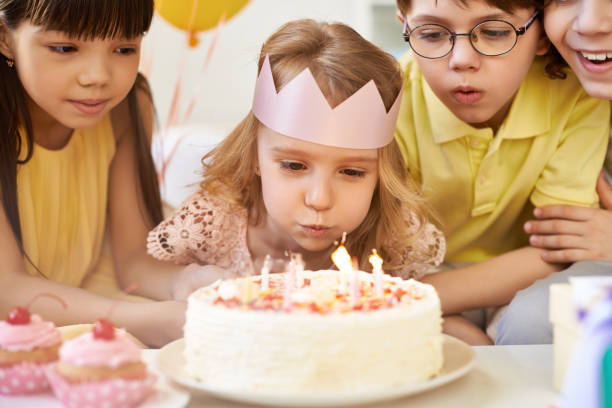 istock Charming girl blowing candles on cake 1151611285