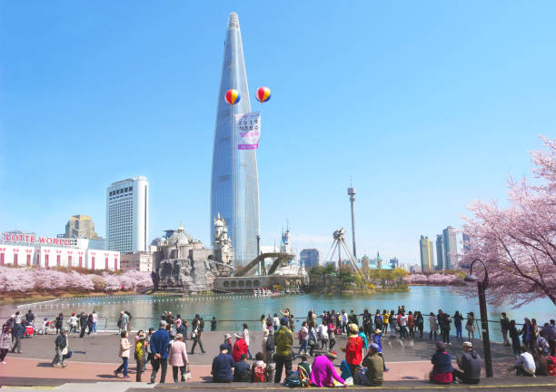 Seoul, South Korea - April 8, 2019: Lotte World Tower at Seokchon Lake park and cherry blossom festival in spring, Seoul, South Korea.