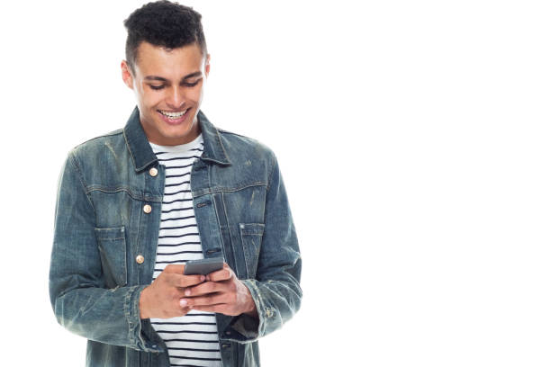 istock Good looking tall black man wearing denim jacket - texting on smart phone 1151614109