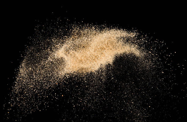 istock Sand flying explosion on black background ,throwing freeze stop motion object design 1151616669