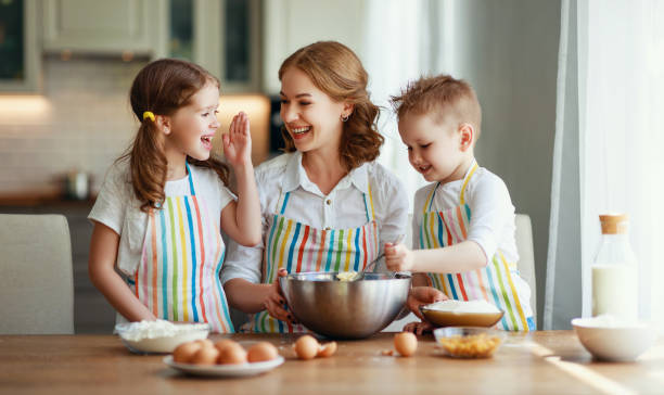happy family in kitchen. mother and children preparing dough, bake cookies happy family in the kitchen. mother and  children preparing the dough, bake cookies 11154 stock pictures, royalty-free photos & images