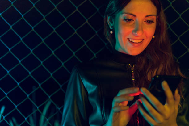 istock Young woman using phone at night 1151619126