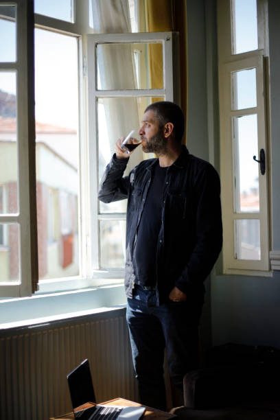 istock Man with coffee cup by the window 1151619813