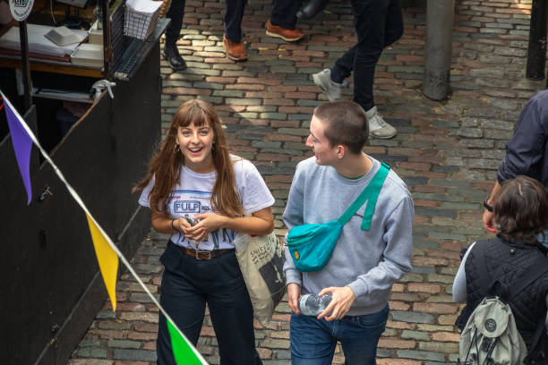 Young couple enjoy hanging out at Camden market London, UK - 18 May, 2019 - Young couple enjoy hanging out at Camden market camden stables market stock pictures, royalty-free photos & images