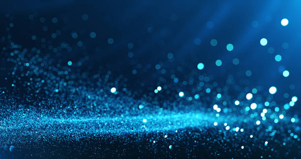gefocuste deeltjes achtergrond (blauw) - glitter stockfoto's en -beelden