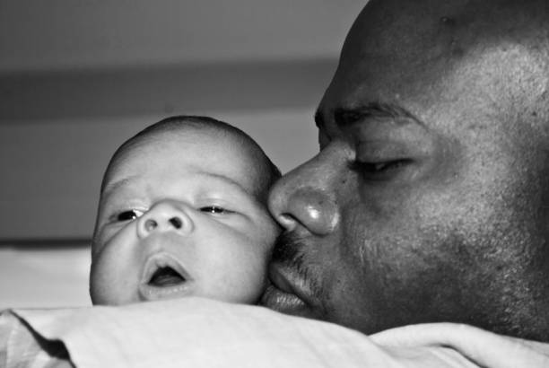 istock Baby looking over parents shoulder 1151622688
