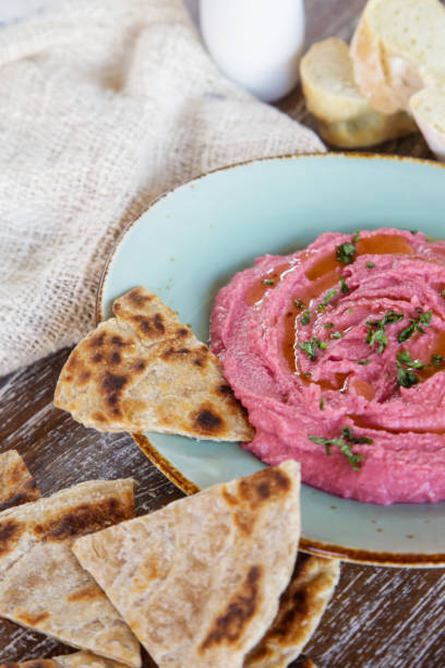 istock Beetroot hummus with pieces of freshly baked naan bread 1151627156