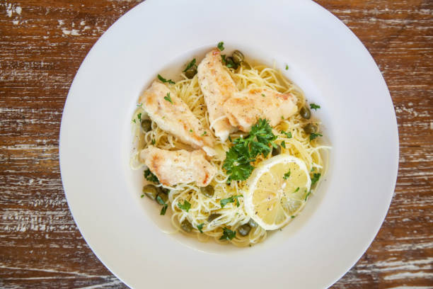 istock Battered salmon fish fillet dinner with noodles on a plate 1151627828